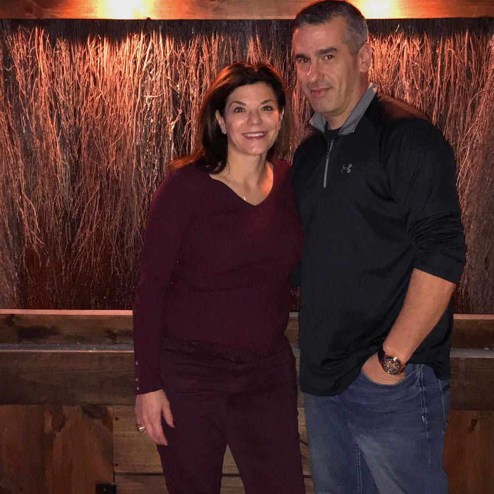 Lisa Mascara and TJ Gentile standing in front of graduation tower at peter's township salt of the earth himalayan salt cave and chakra boutique location south of pittsburgh